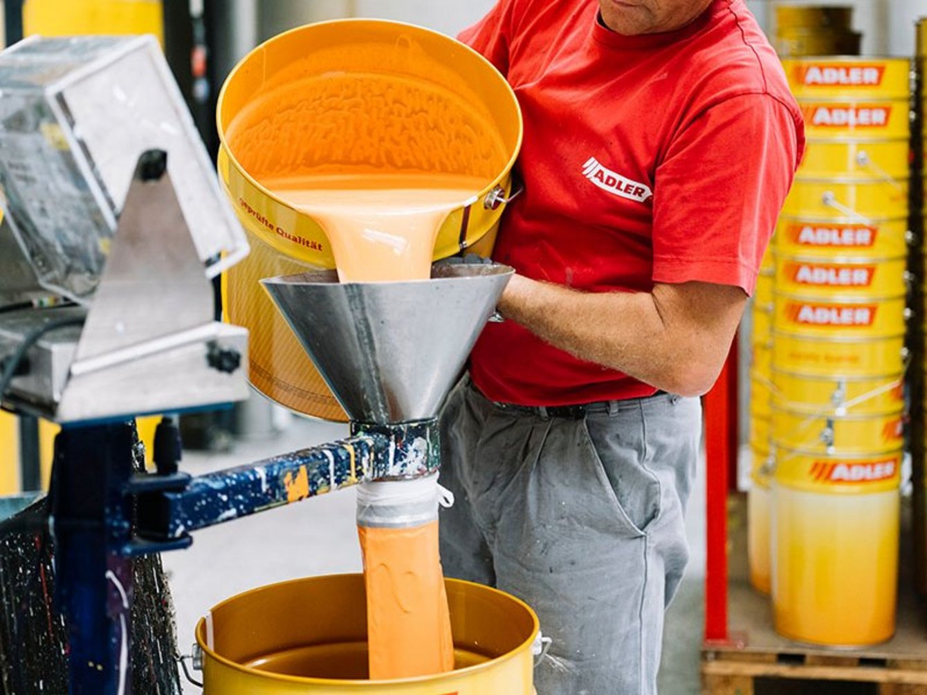 Produktion bei ADLER Mitarbeiter der Produktion bei ADLER Lacke gießt Lack